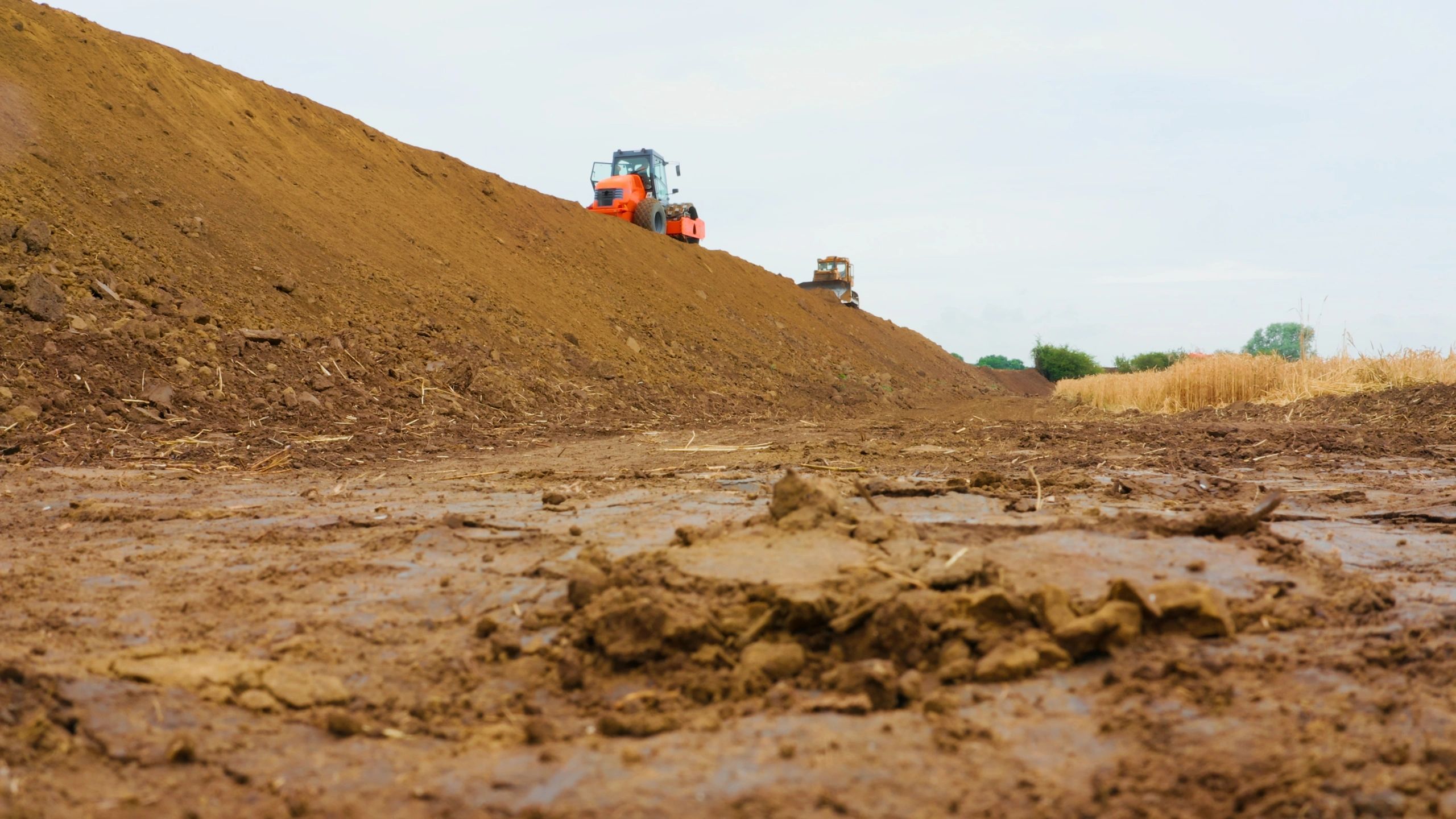 Heavy machinery performing earthworks at a commercial construction site